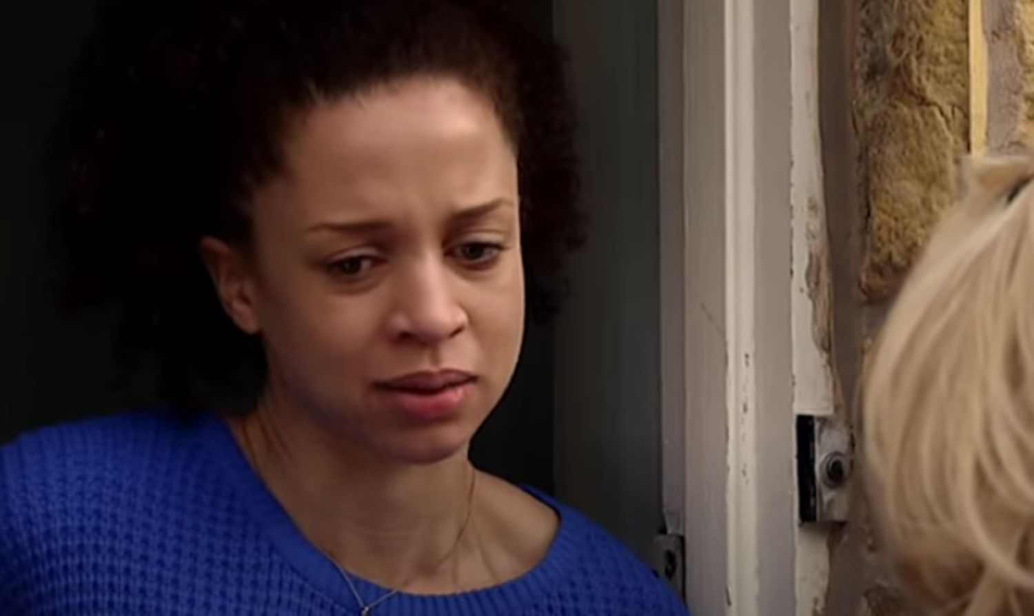 Kirsty looking upset stood in the doorway in Coronation Street