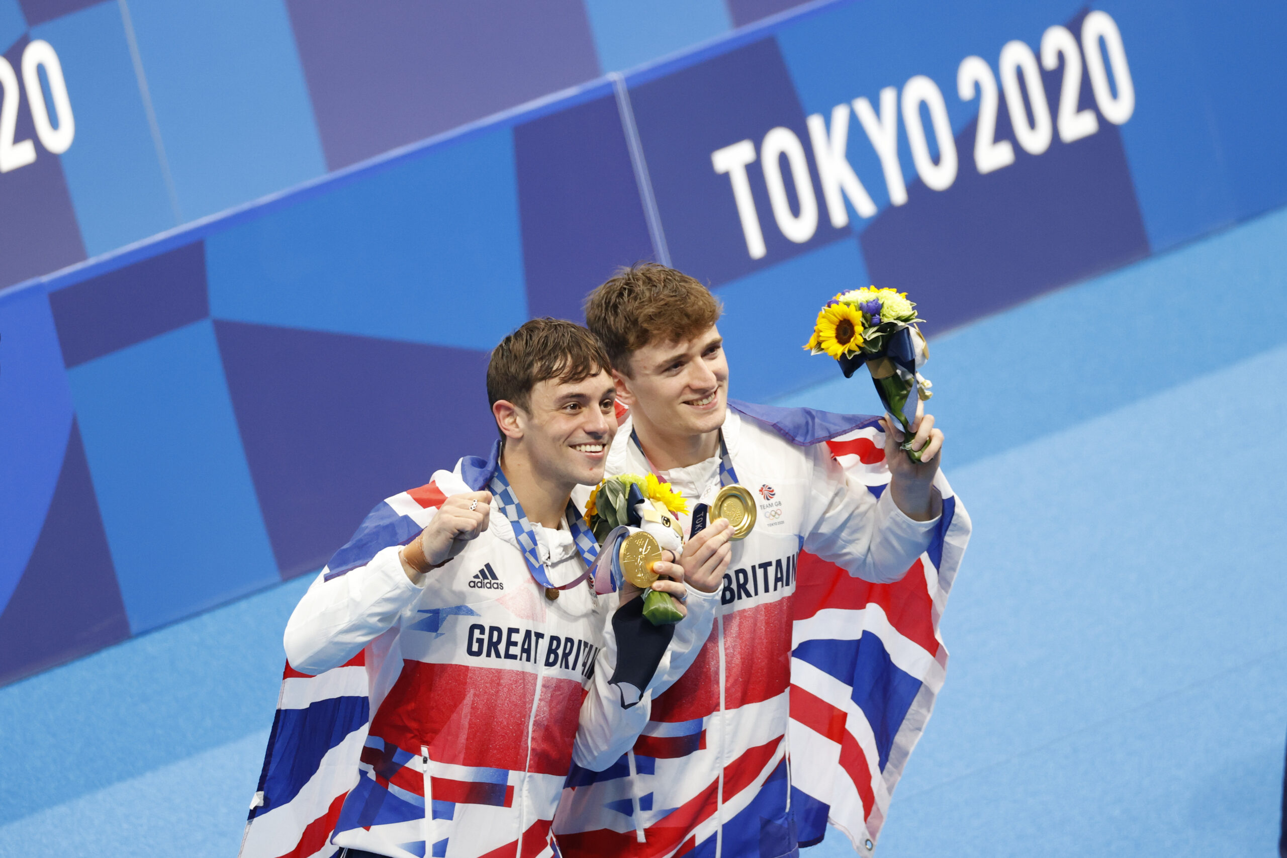 Tom Daley and Matty Lee celebrate winning thier gold medals dressed in Team GB attire at Tokyo 2020 Olympics