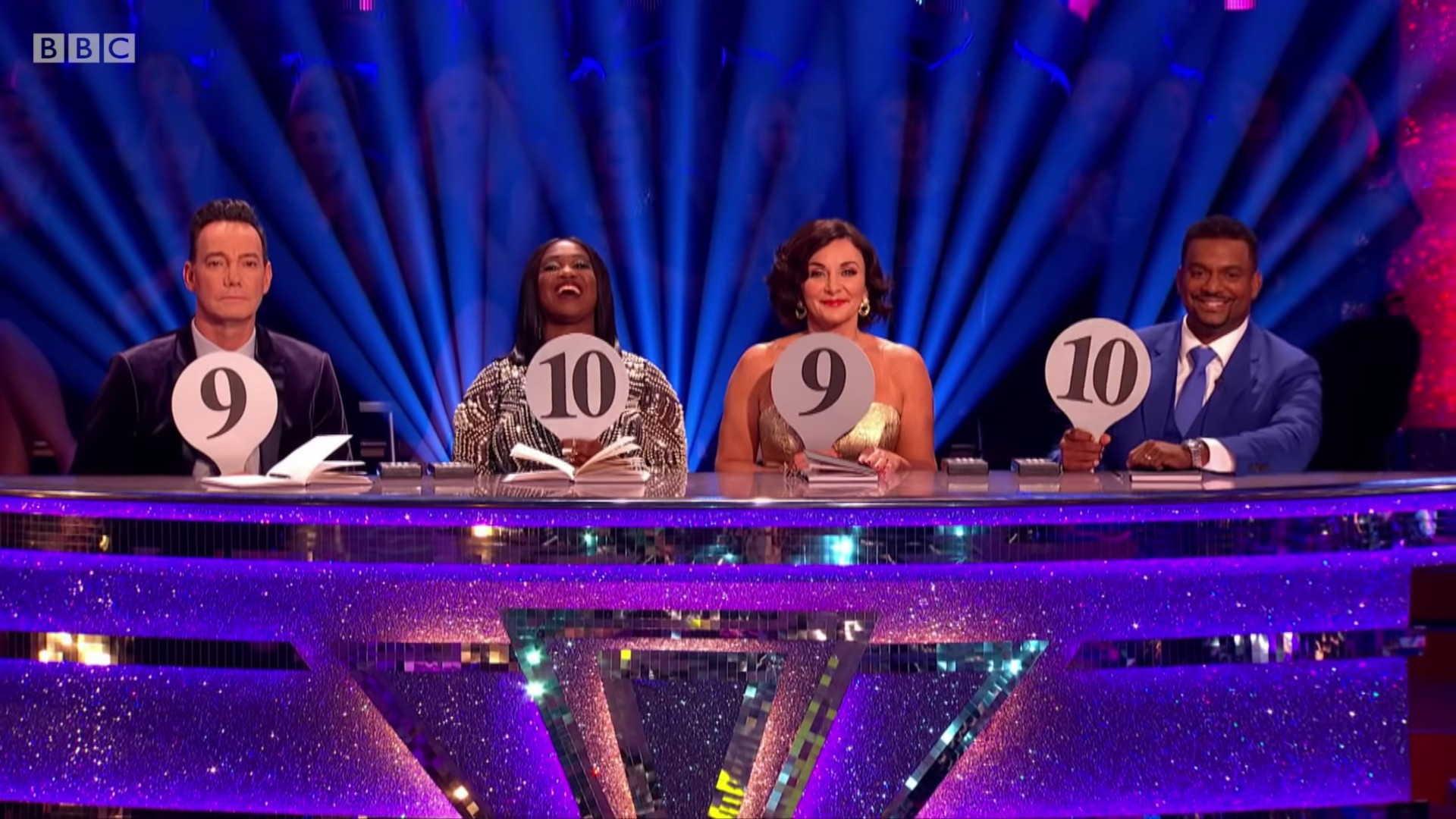 The Strictly Come Dancing judging panel holding up score cards