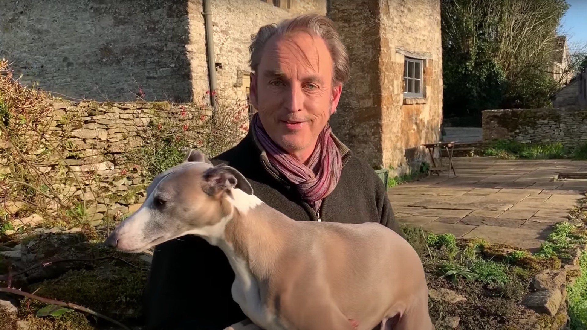 Phillip Mould holding his whippet dog