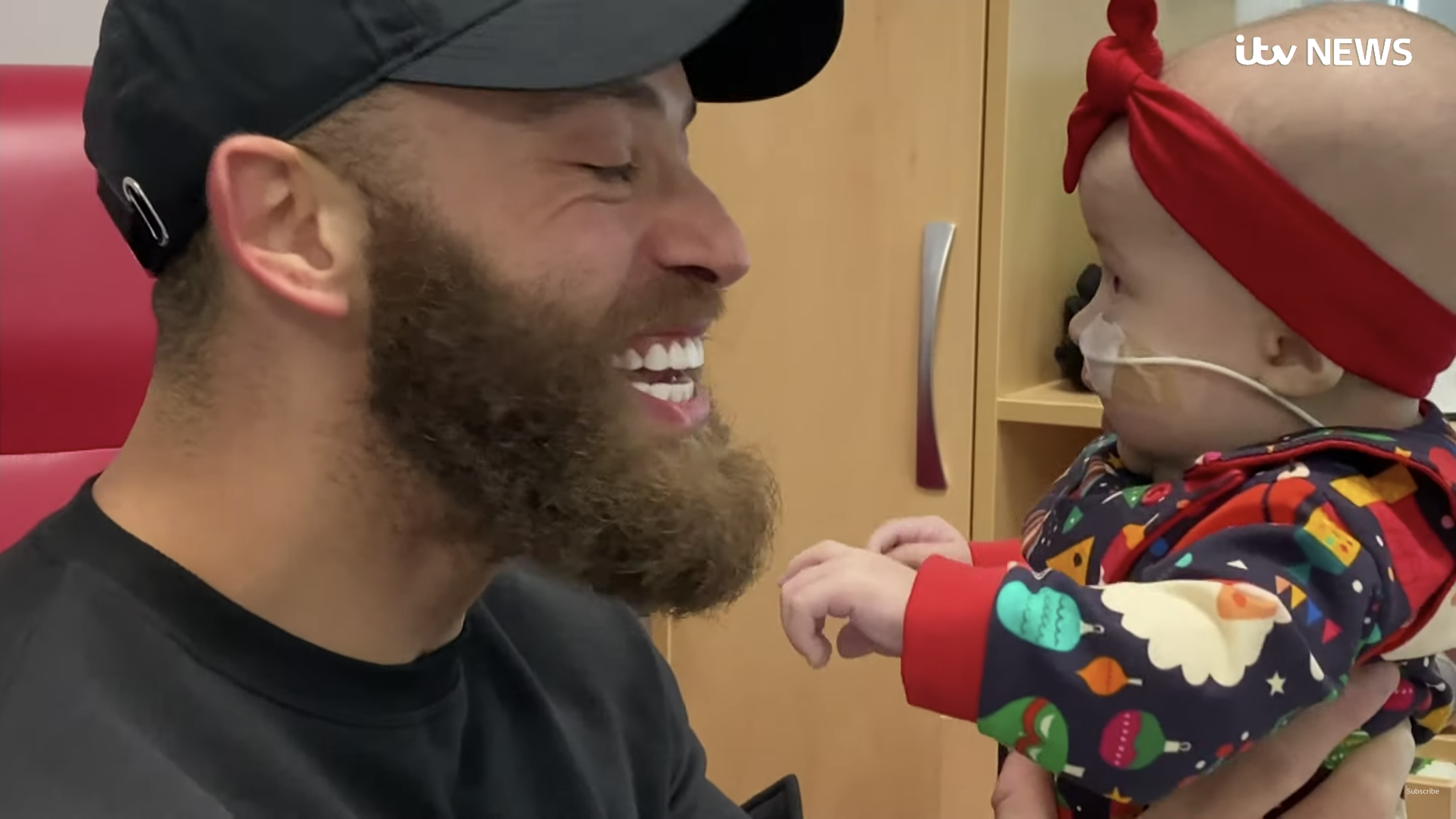 Ashley Cain smiling holding baby daughter Azaylia