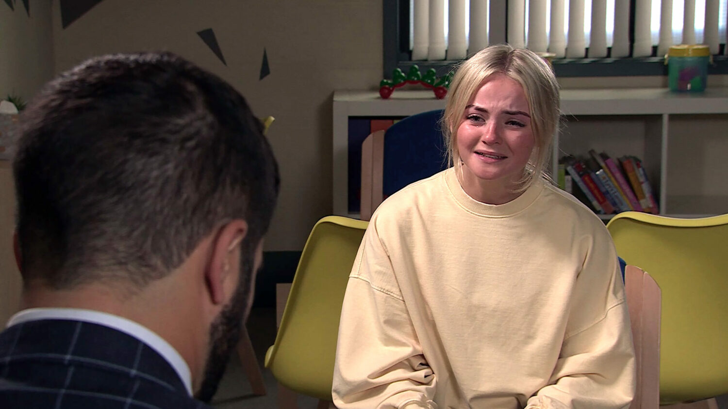 Kelly Neelan in Coronation Street crying as she talks to foster dad Imran