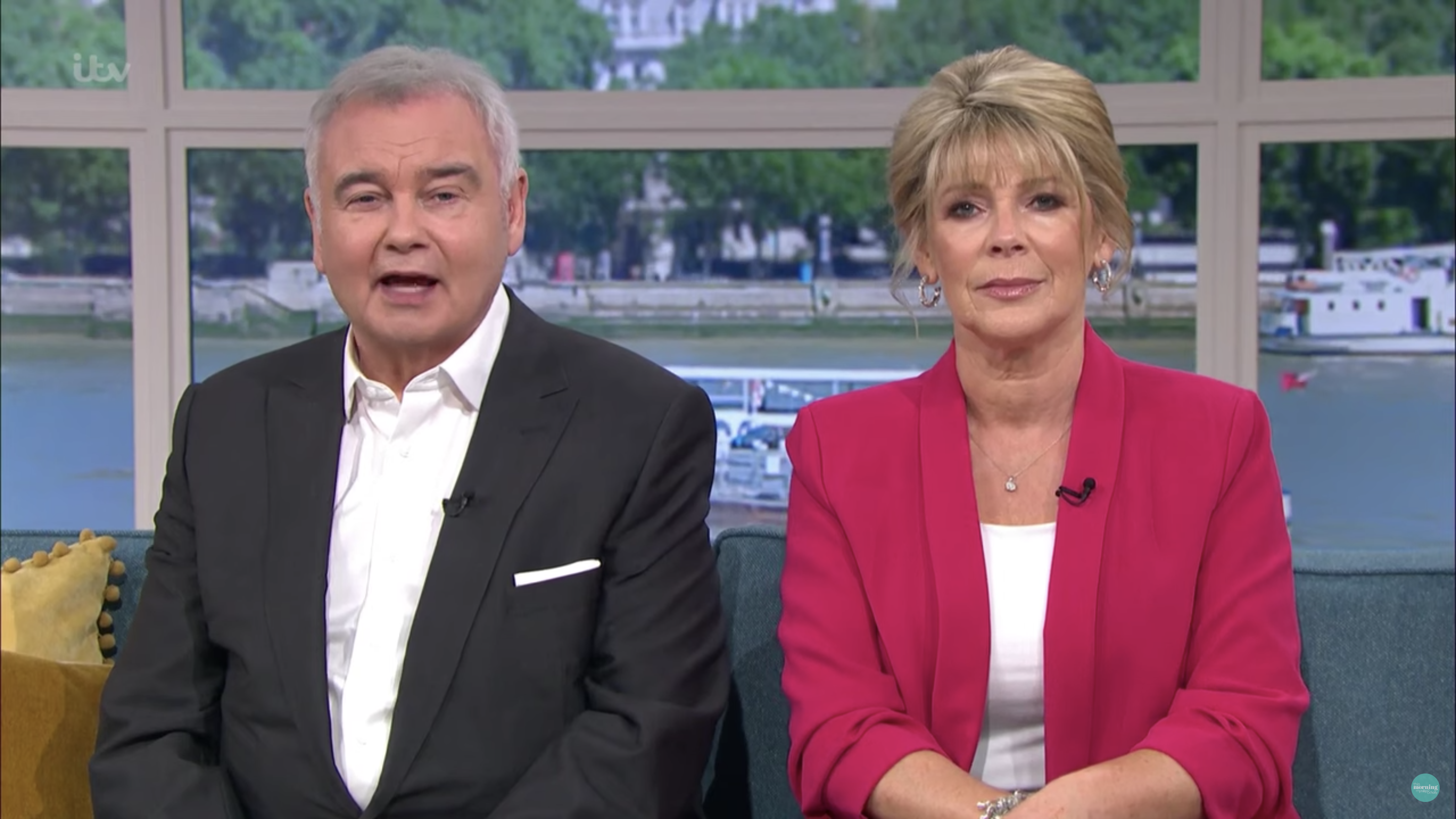 Ruth Langsford wearing a hot pink blazer and white top with her hair pinned up as she co-hosts This morning with husband Eamonn Holmes