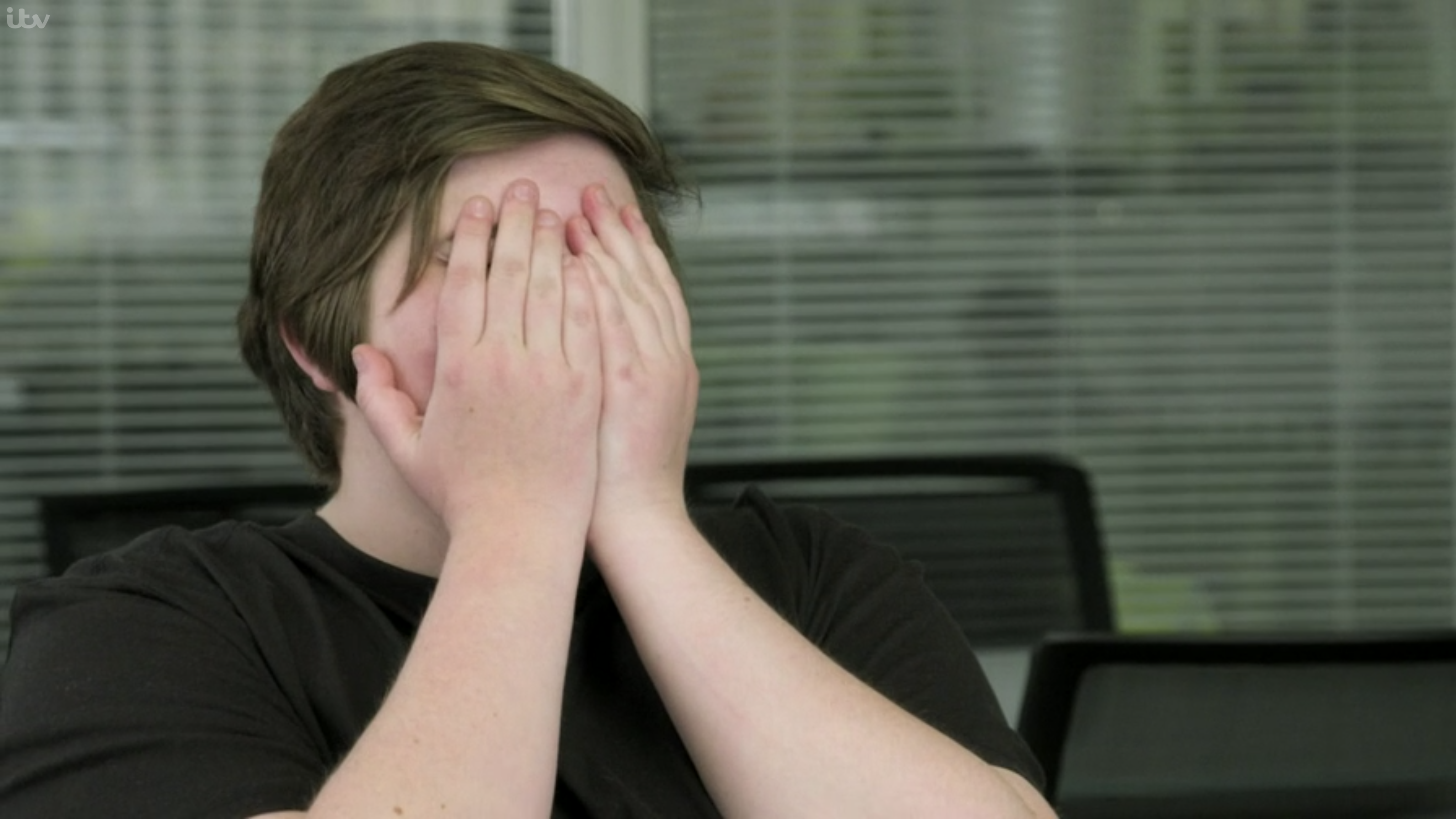 Overcome Jess covers her face with her hands 