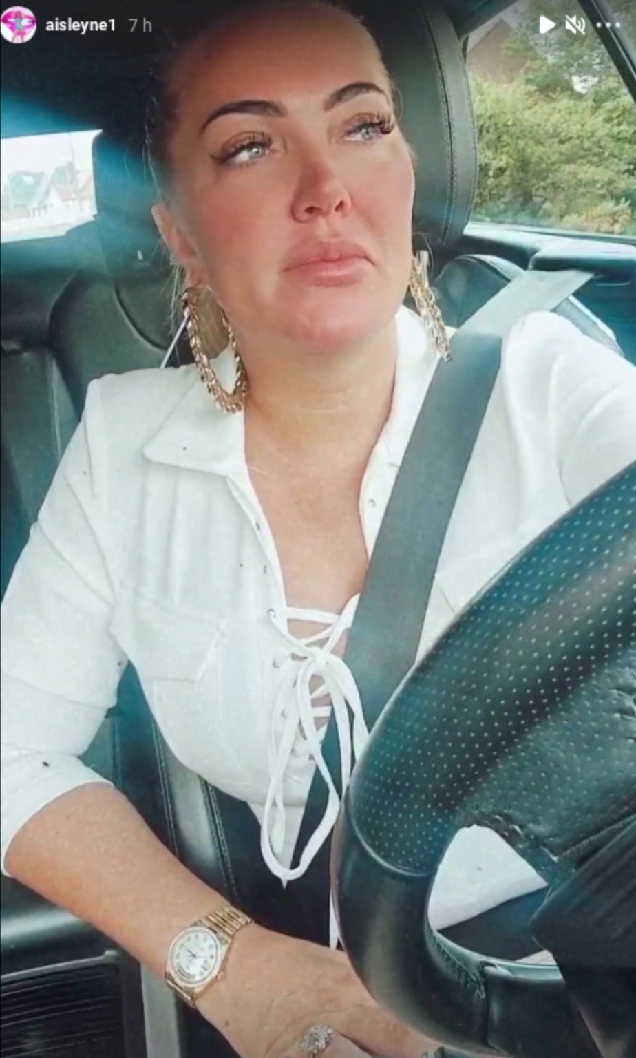 Aisleyne Horgan-Wallace cries in her car wearing a white shirt 