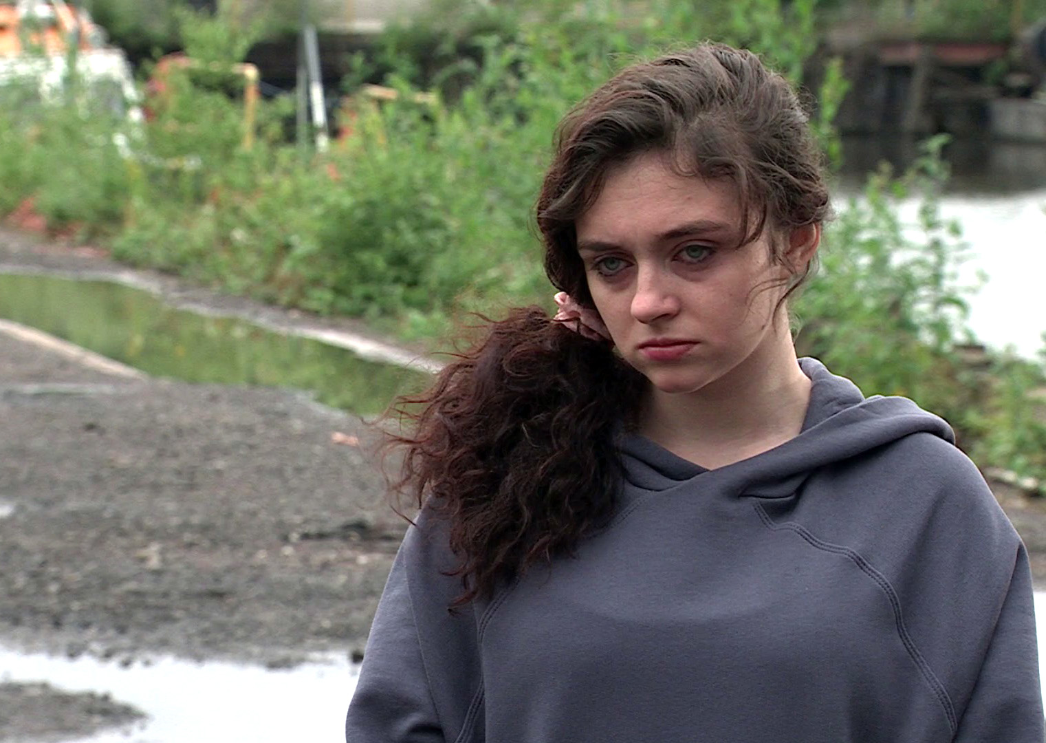 Nina on Coronation Street in a grey hoodie