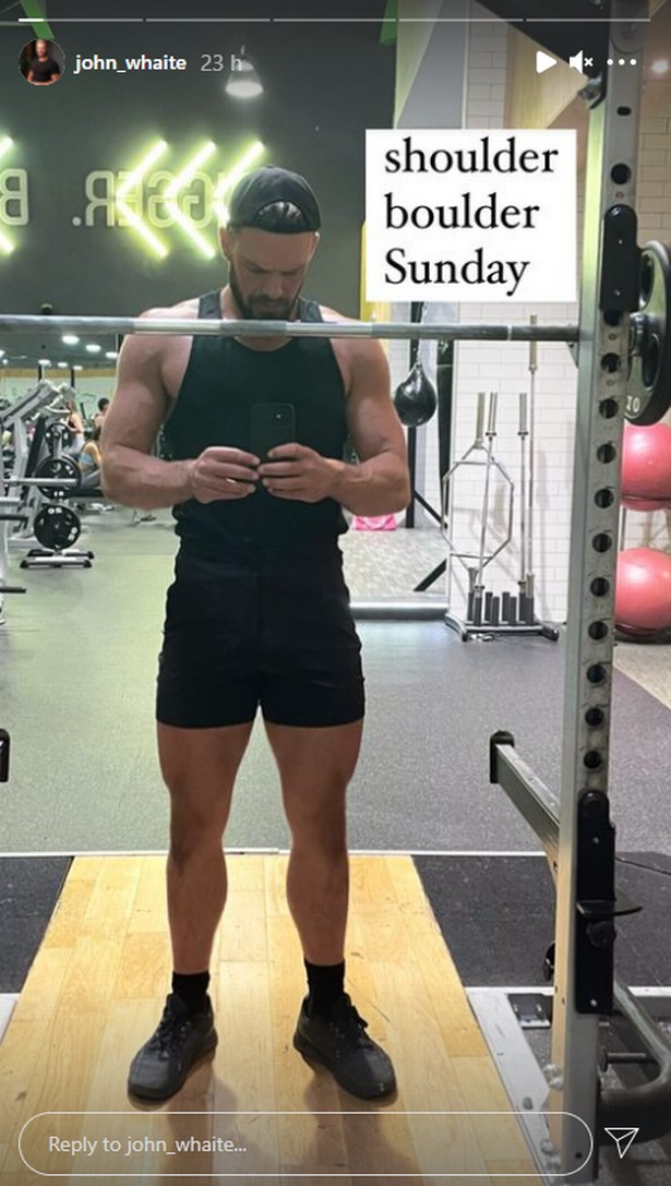 John Whaite in the gym dressed all in black taking a mirror selfie
