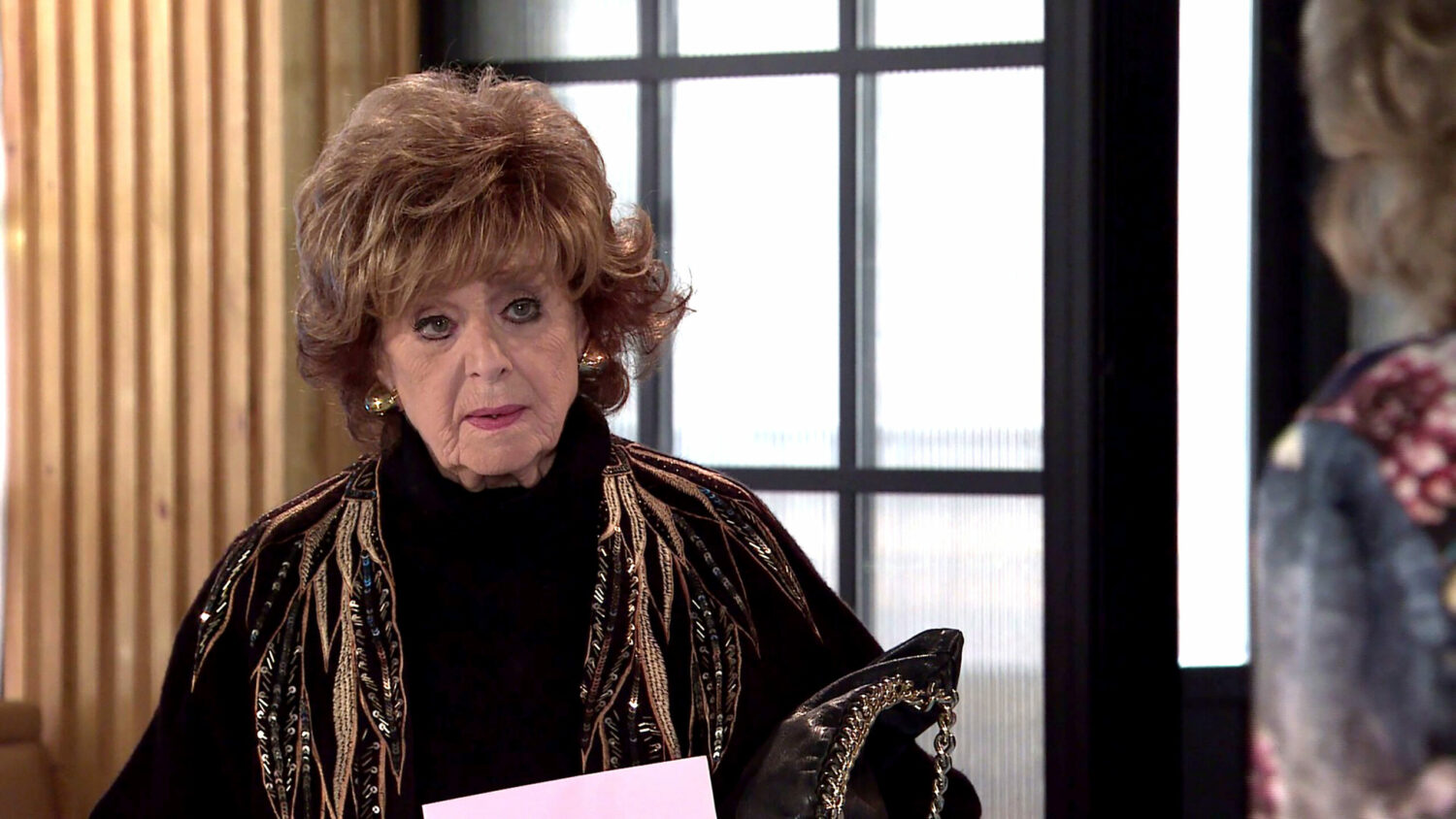 Rita Tanner looks at Audrey with annoyance in her eyes