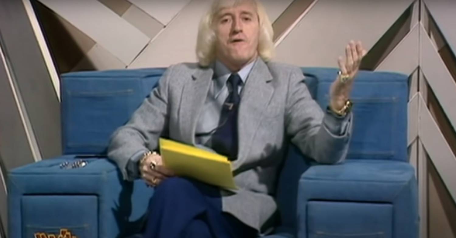 Jimmy Savile presenting Jim'll Fix It in the infamous blue chair
