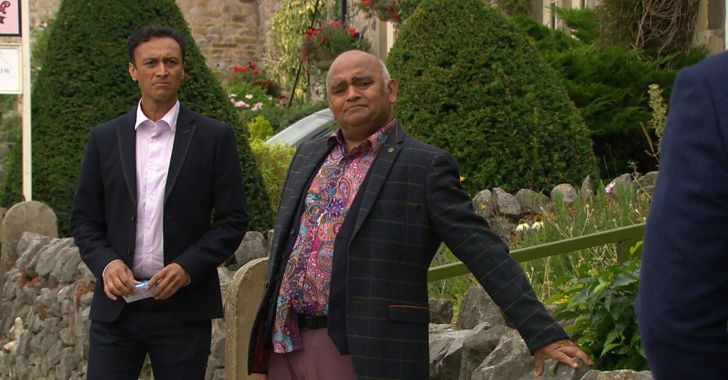 Emmerdale Jai looks annoyed as Rishi looks upset confronting Charles 