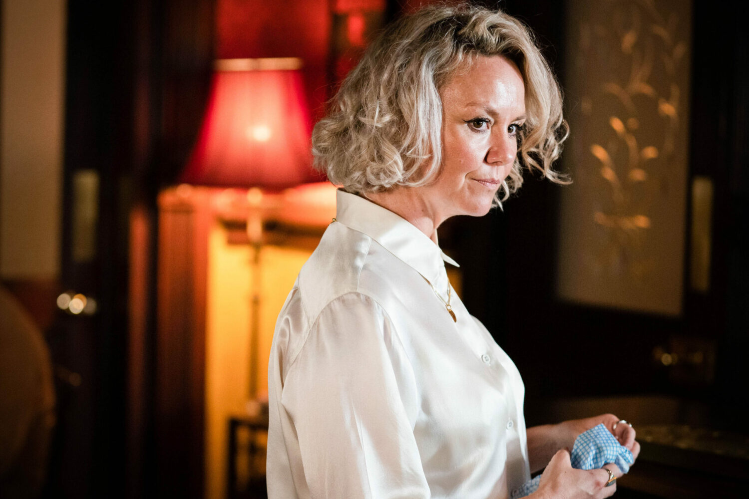 Janine Butcher looks shifty as she works in The Vic in EastEnders