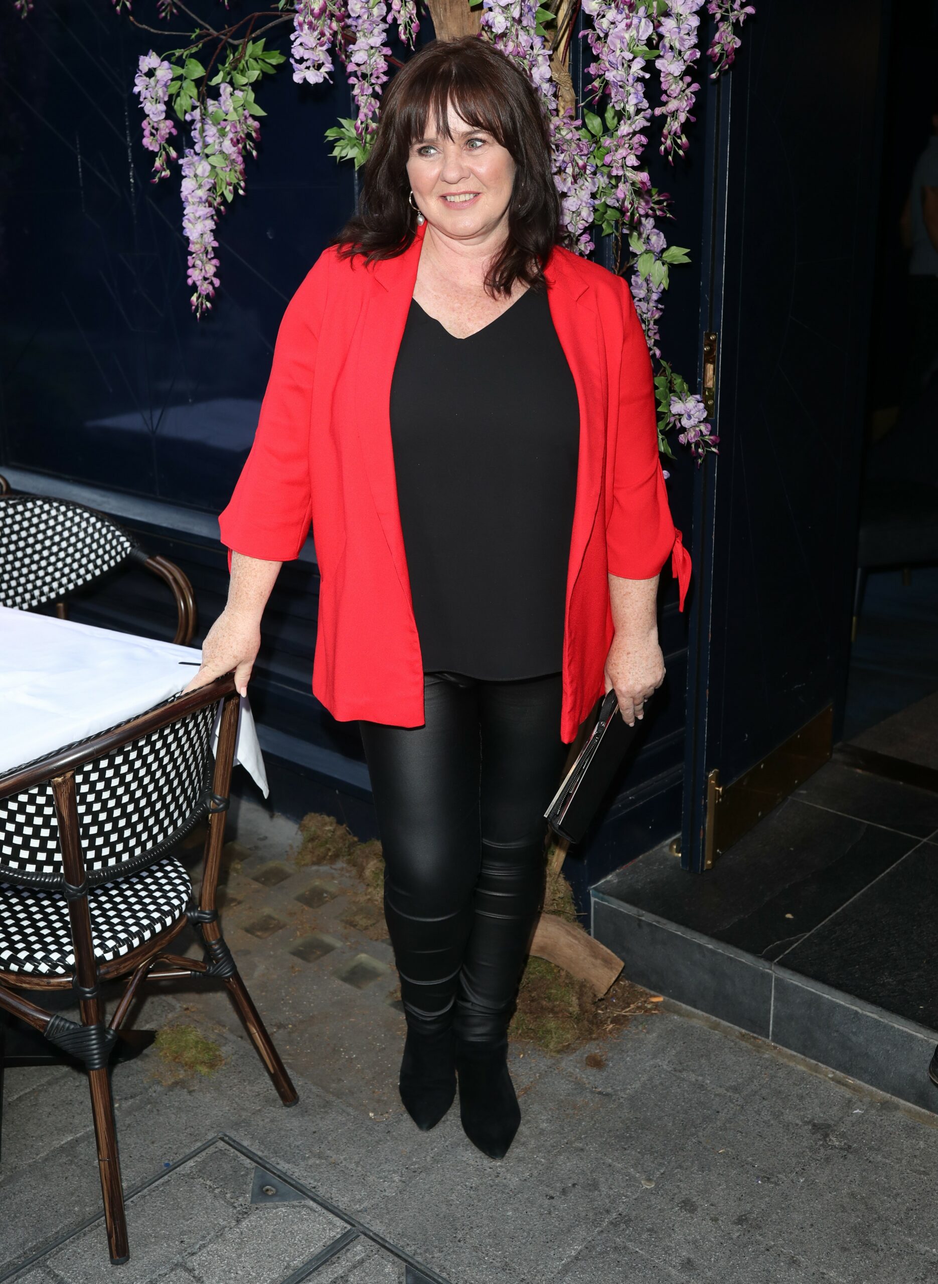 Coleen Nolan wears red jacket at event 