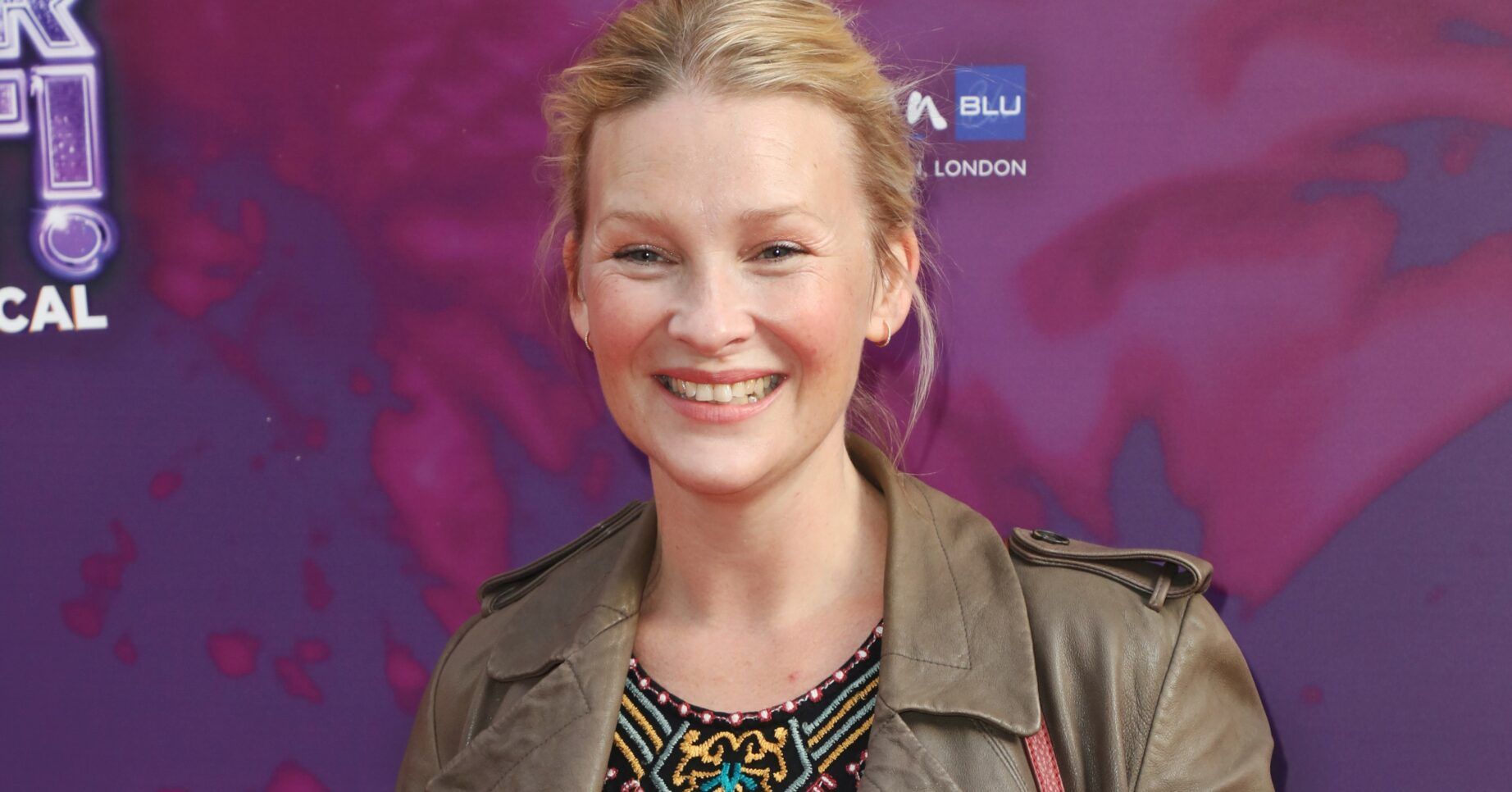 Joanna Page smiles on red carpet