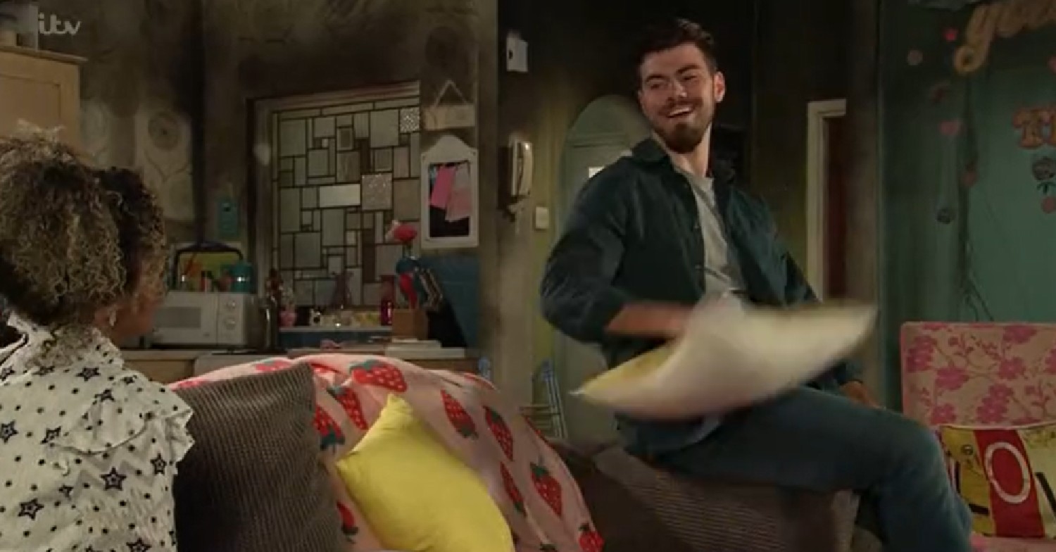 Coronation Street Emma and Curtis laugh and joke in the fire damaged flat with smoke damaged walls behind them