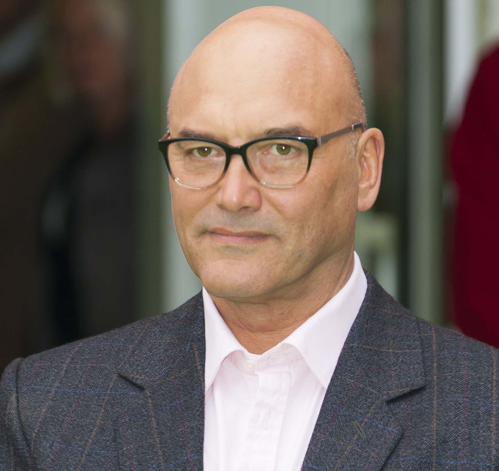 Celebrity MasterChef star Gregg Wallace with a hint of a smile dressed in a suit