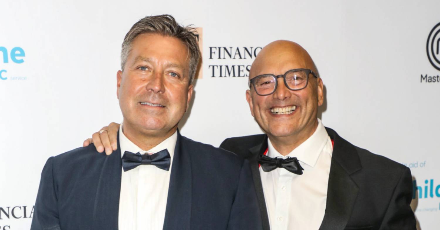 John Torode smiling with his fellow Masterchef judge Gregg Wallace