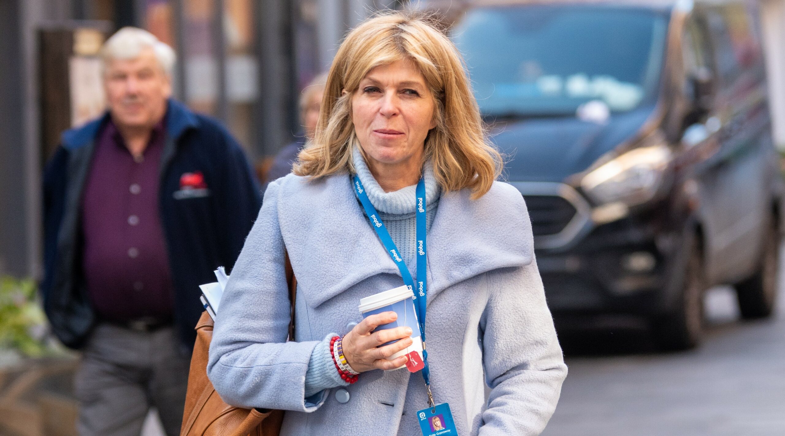 Kate Garraway smiles as she leaves radio studio with a coffee