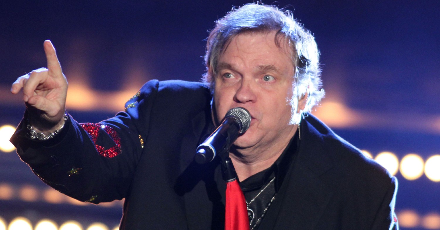 Meat Loaf singing into a microphone on stage