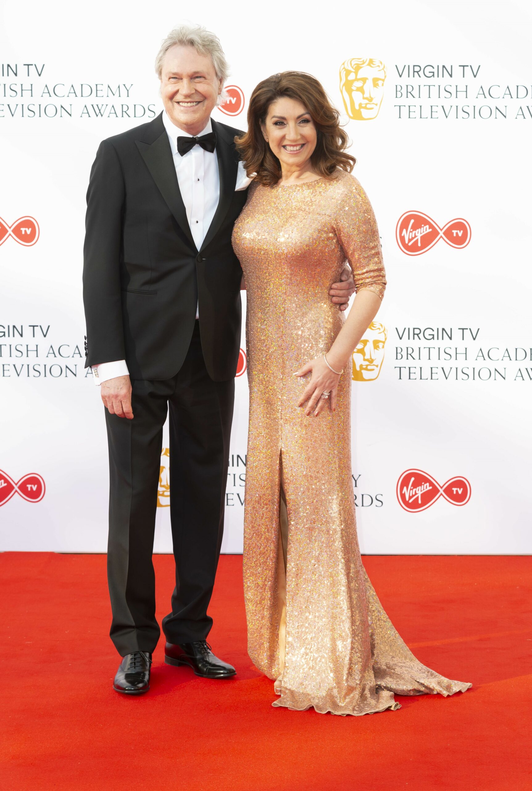 Jane McDonald smiling with partner Ed at BAFTAs