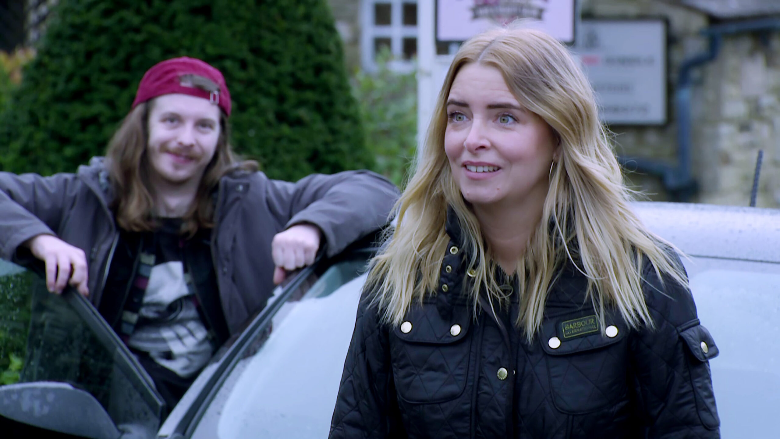 Ryan steps out the car and Charity smiles as they are revealed as the new Woolpack owners in Emmerdale