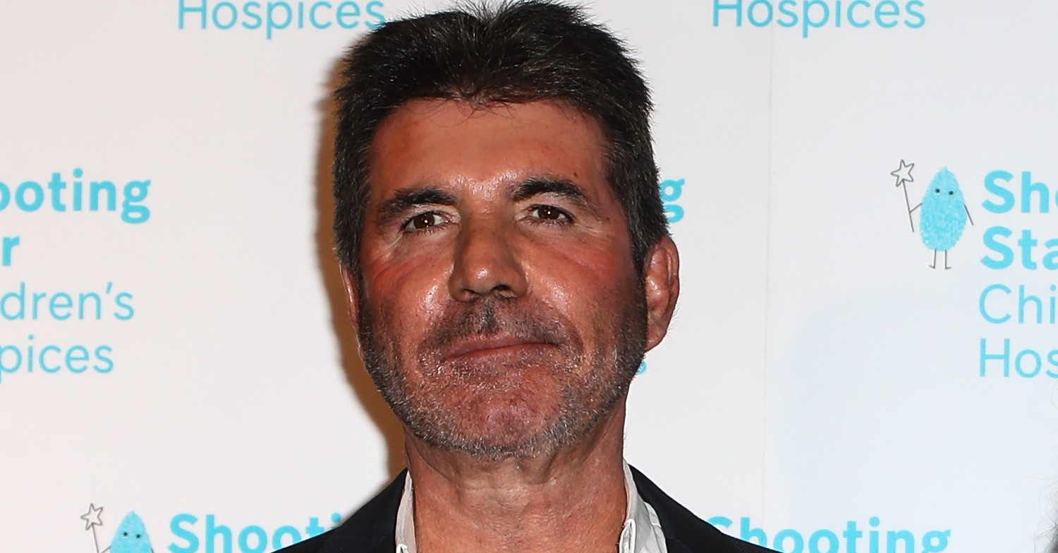 Simon Cowell smiling faintly at a charity do