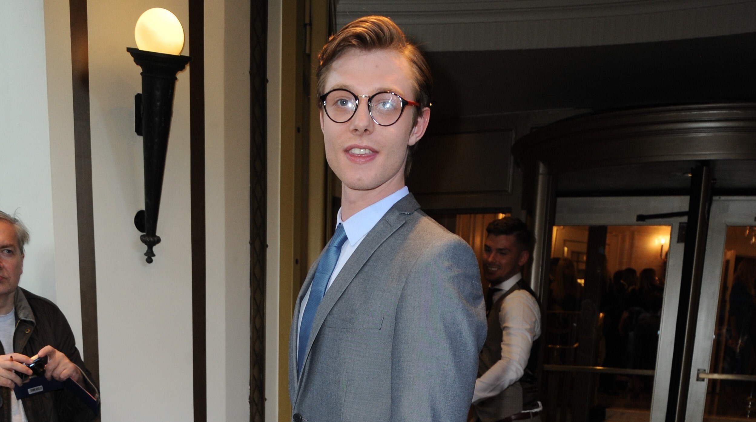 Rob Mallard smiles at the TV Choice Awards in glasses and a grey suit