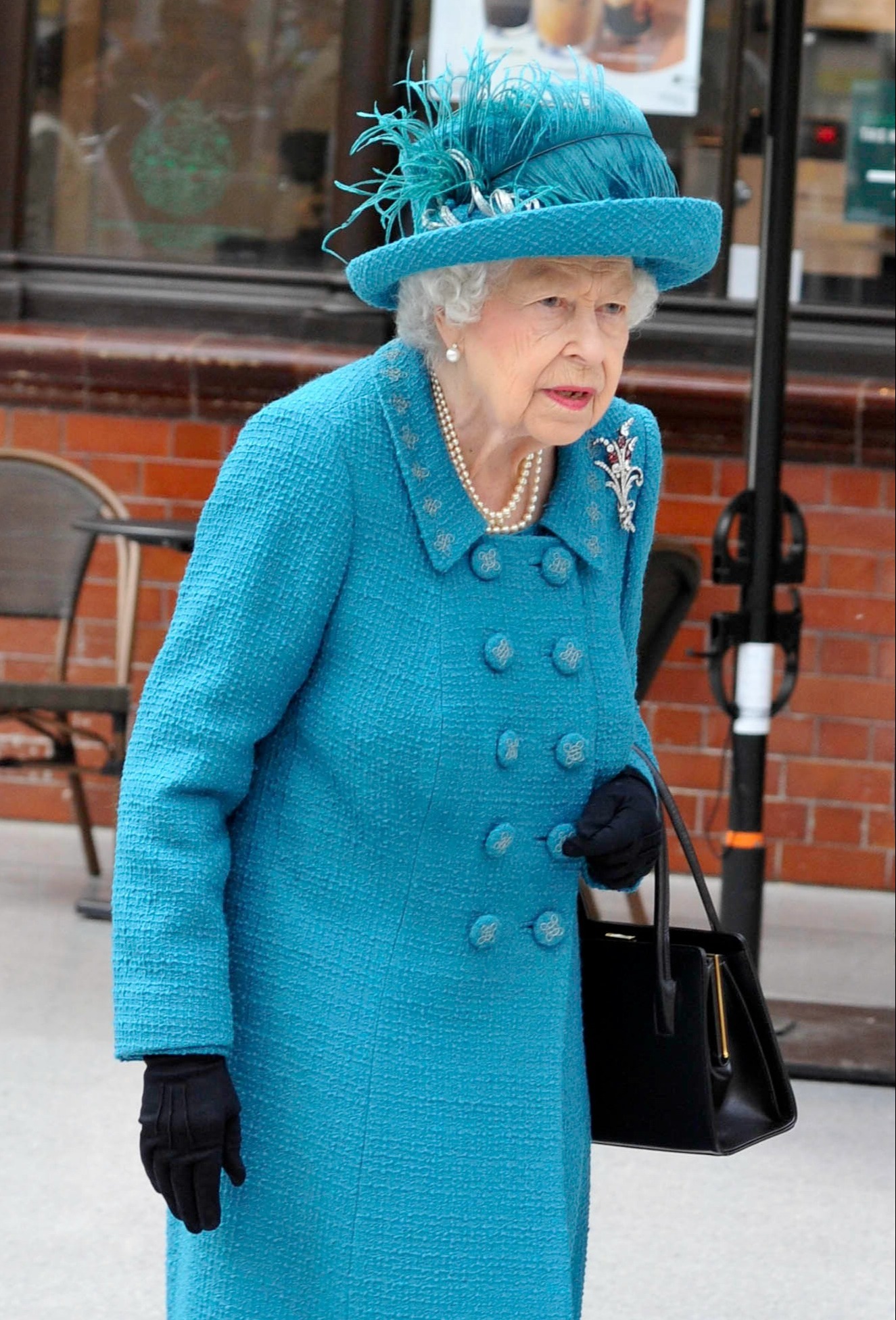 The queen wearing a blue coat