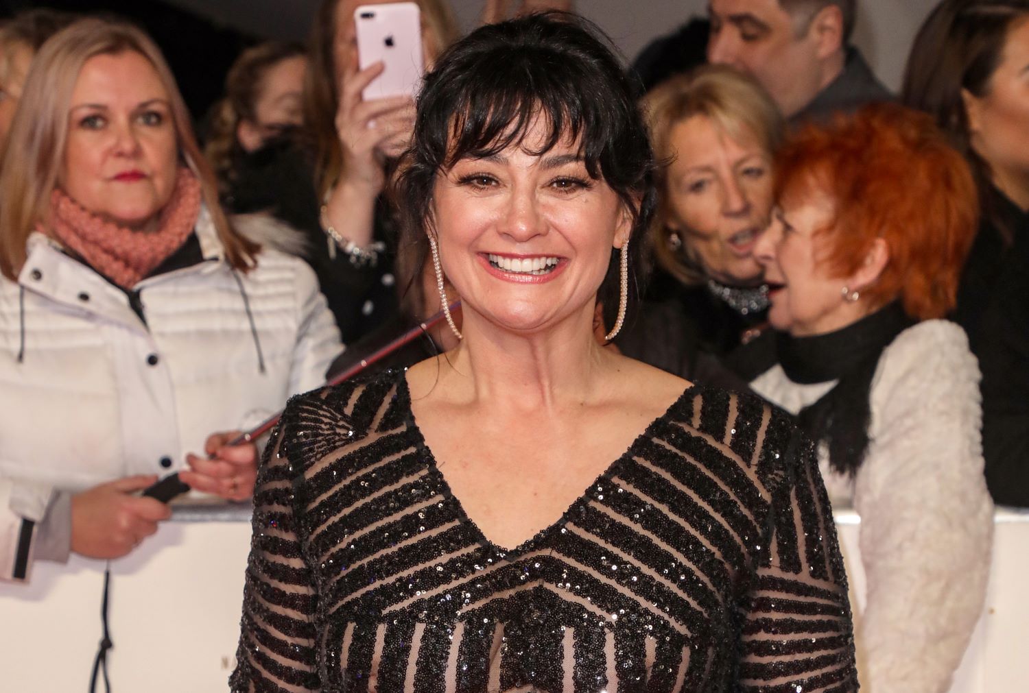 Natalie J Robb smiles on the red carpet at the NTAs