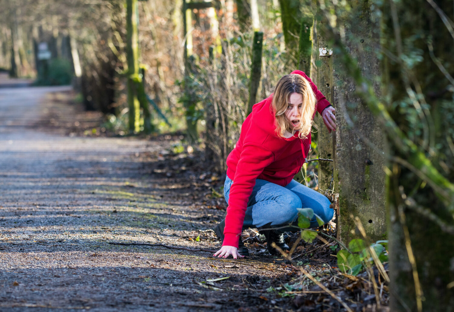 Coronation Street Abi crouches on the side of the road in agony
