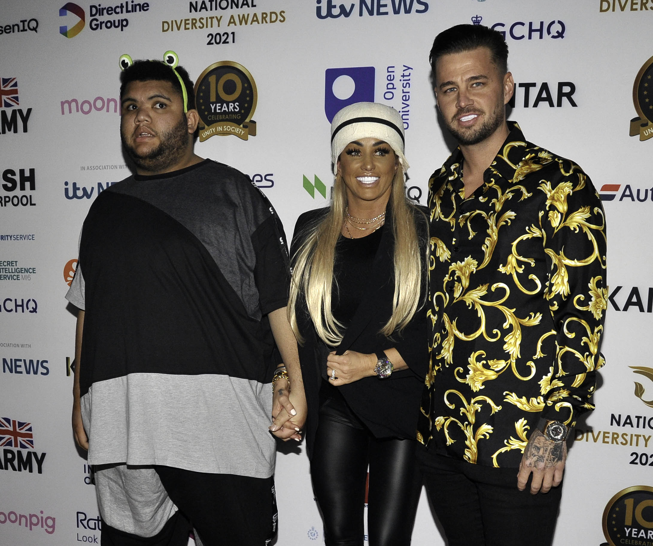 Katie Price with her son Harvey and boyfriend Carl Woods an an event