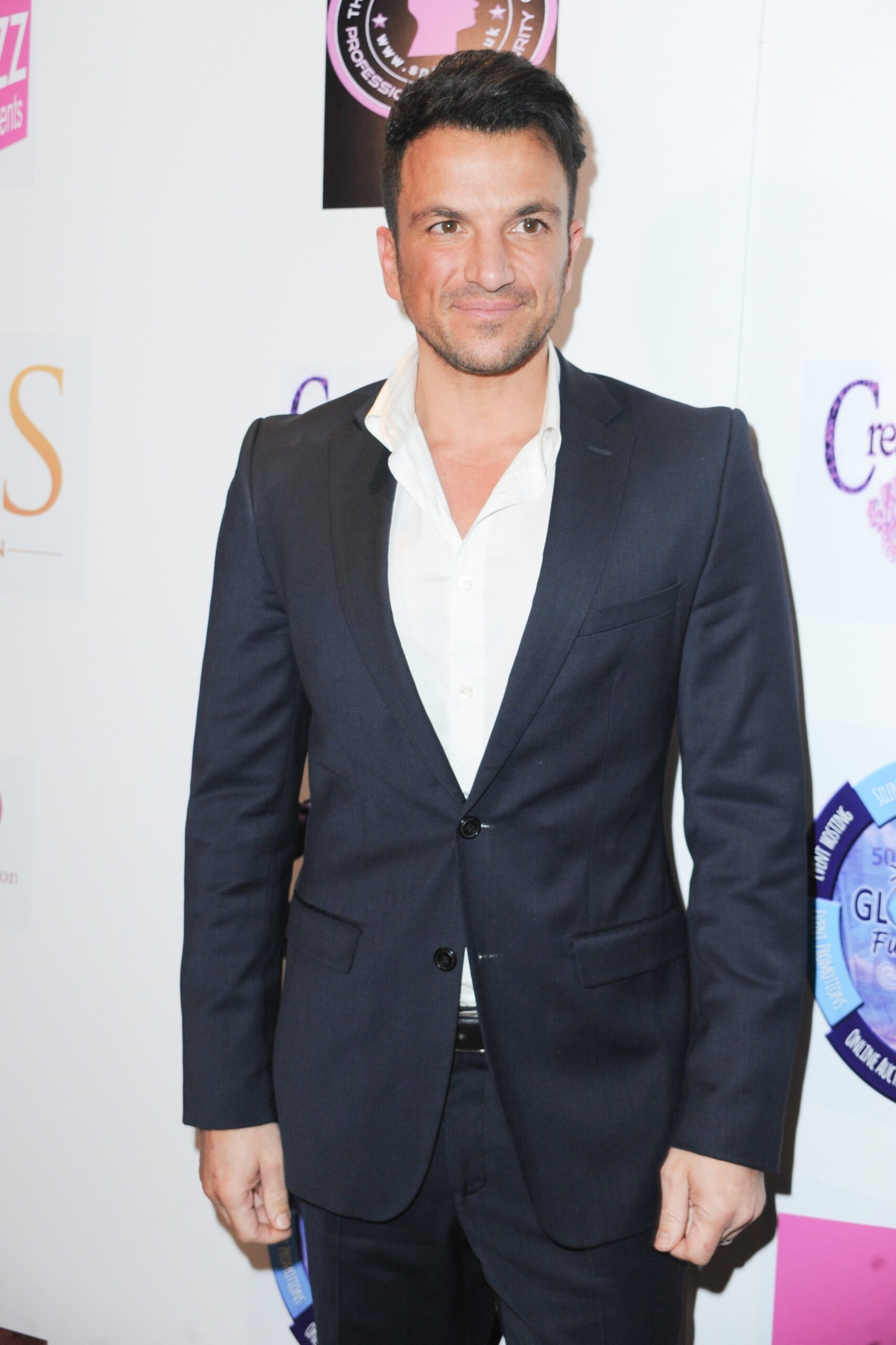 Peter Andre looking blankly wearing a suit on the red carpet