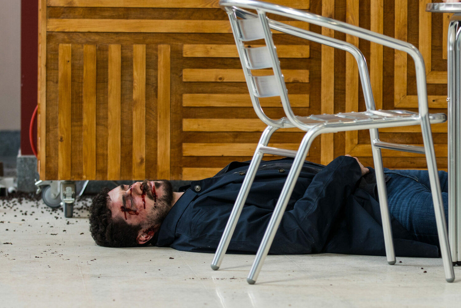 Corrie Adam is bloody and unconscious after Lydia pushed him off the balcony