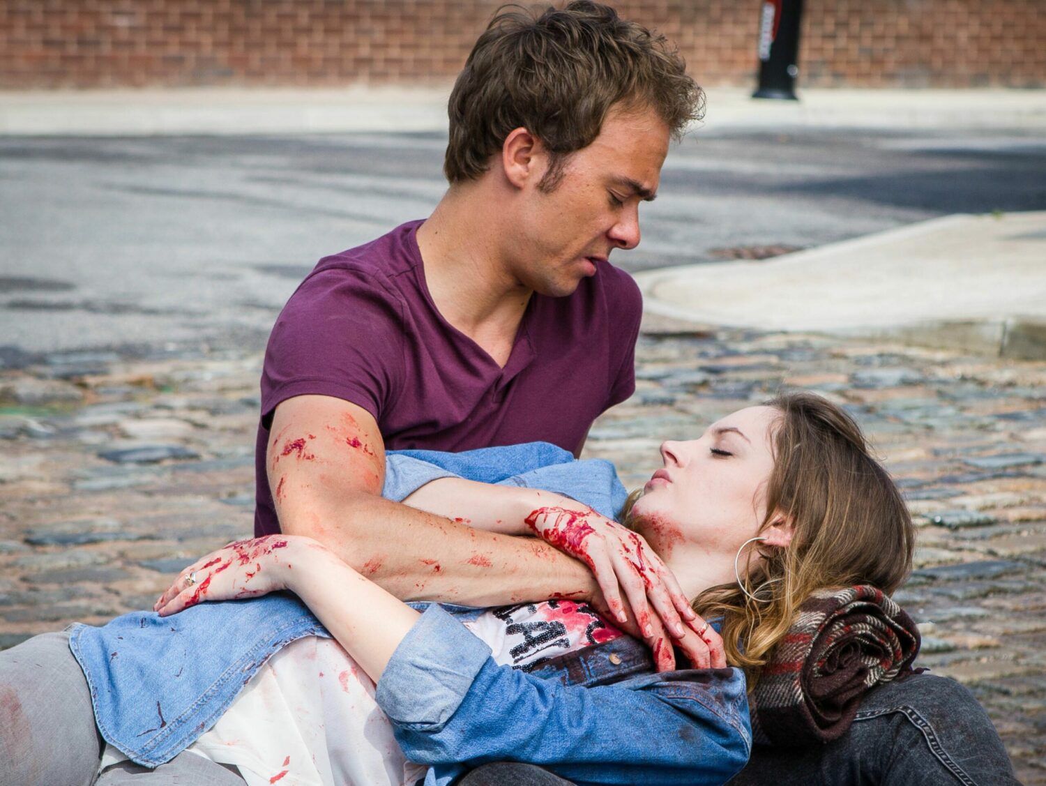 David in Coronation Street craddles bleeding wife Kylie in his arms after she is stabbed