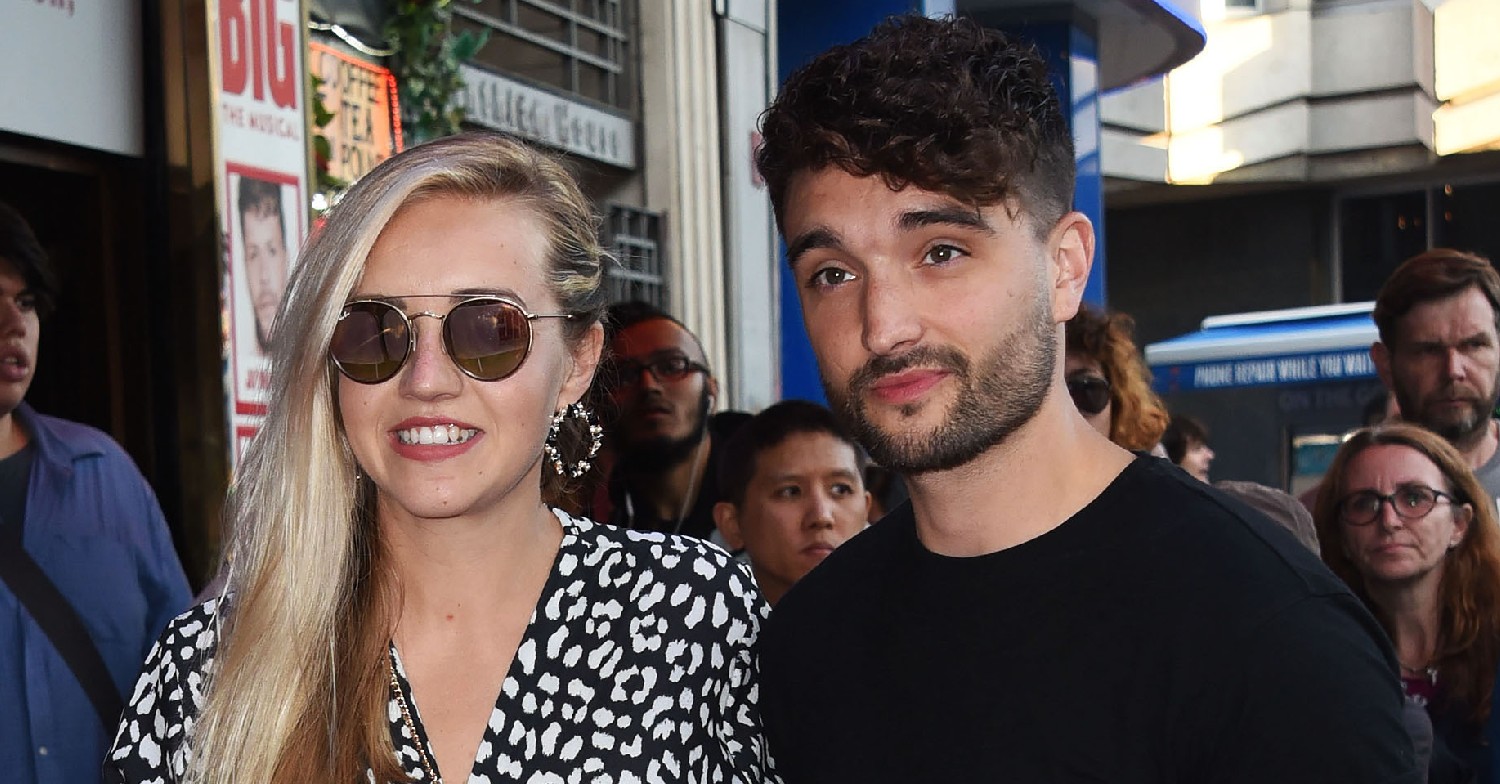 Tom Parker and his wife, Kelsey Hardwick, posing for photos on a red carpet event 