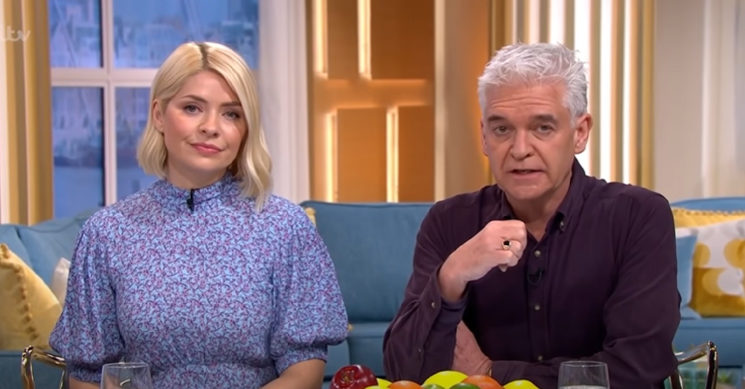 Holly Willoughby, in a blue dress, hosts This Morning with Phillip Schofield