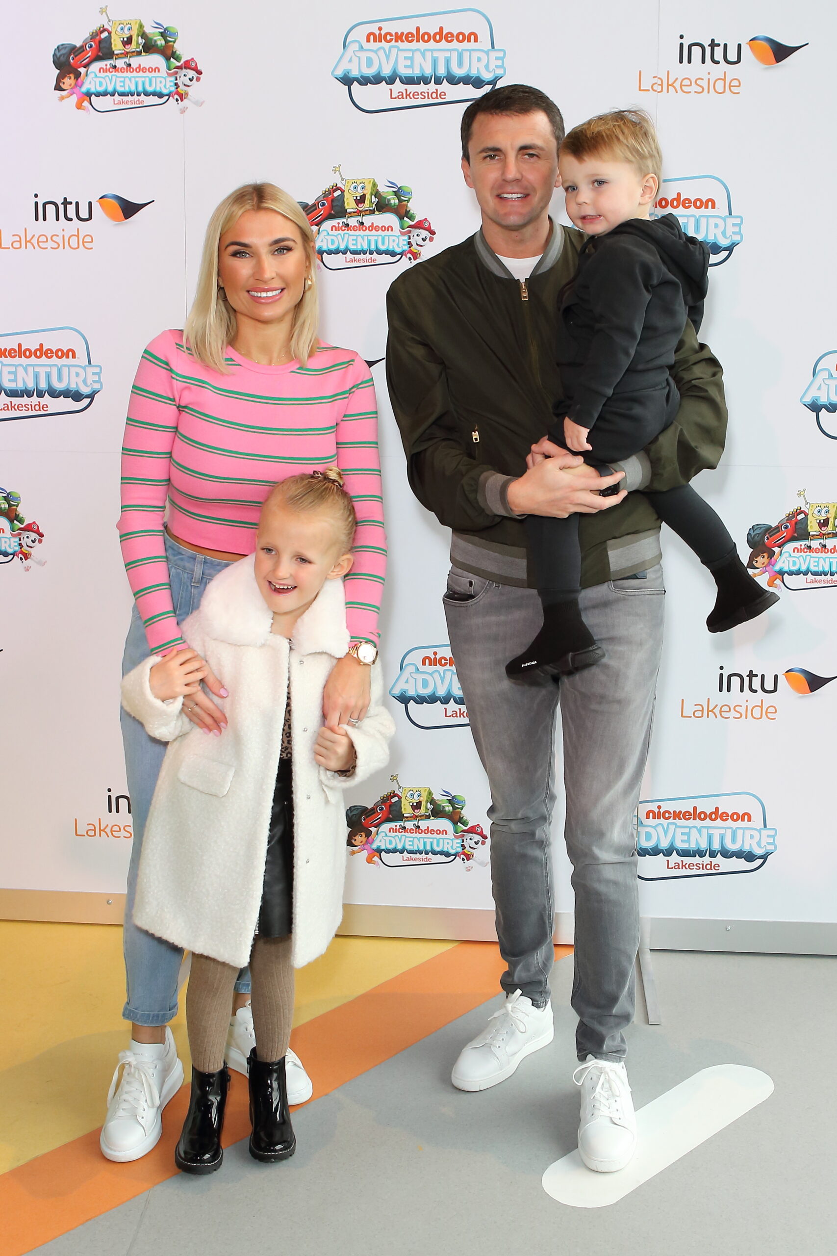 Billie Faiers at an event with her husband and kids