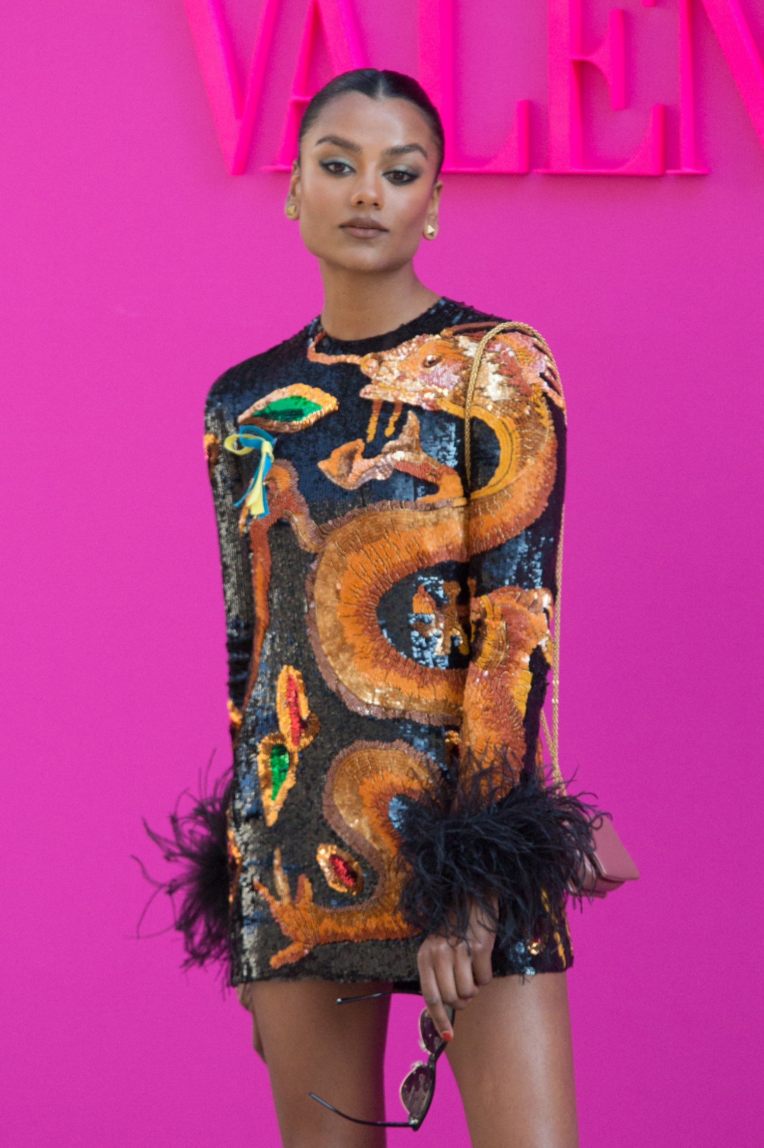 Simone Ashley posing in a mini dress