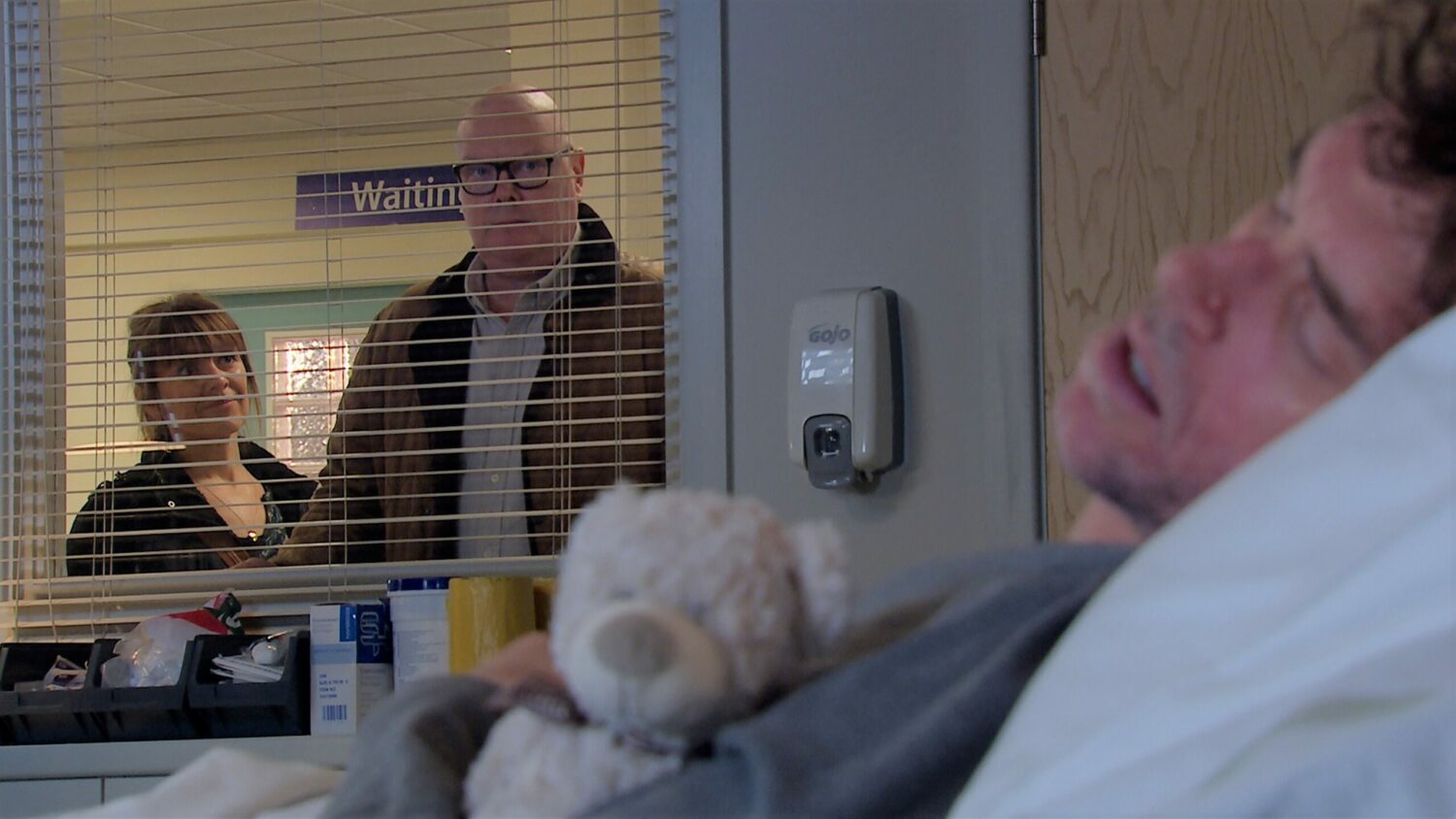 Marlon in his hospital bed clutching a teddy