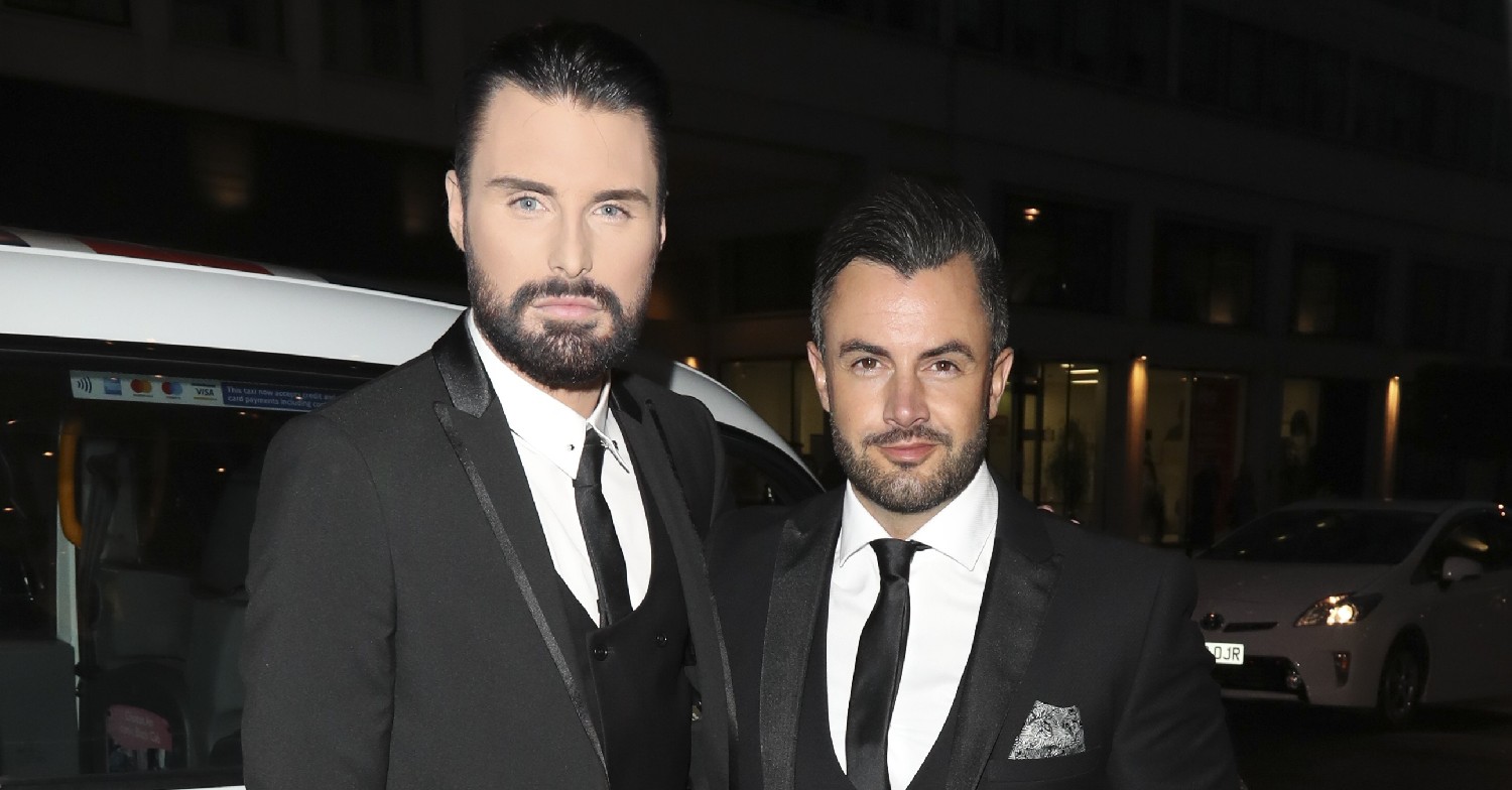 Rylan Clark and Dan Neal wearing suits posing for the camera