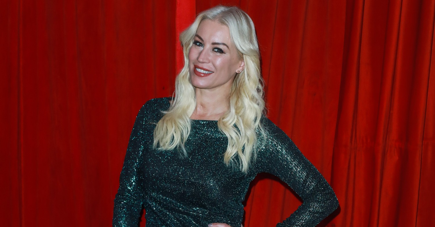 Denise van Outen in green dress smiling for the cameras