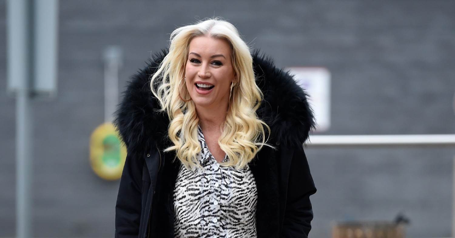 Denise Van Outen smiling for cameras while on a walk