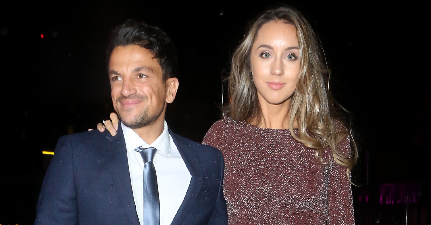 Peter Andre and wife Emily Andre smiling for the cameras out at night