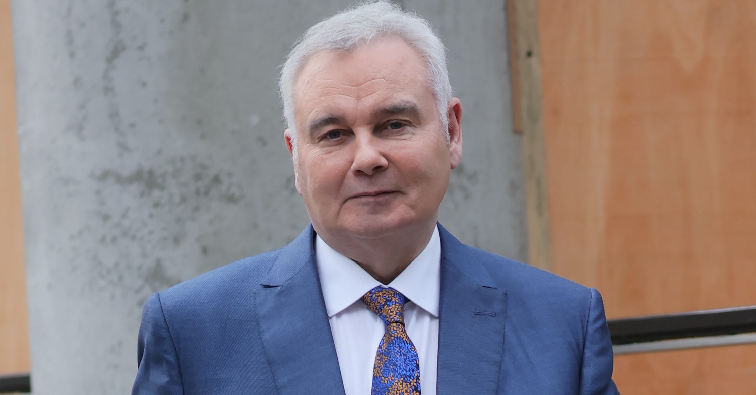 Eamonn Holmes smiles in blue suit