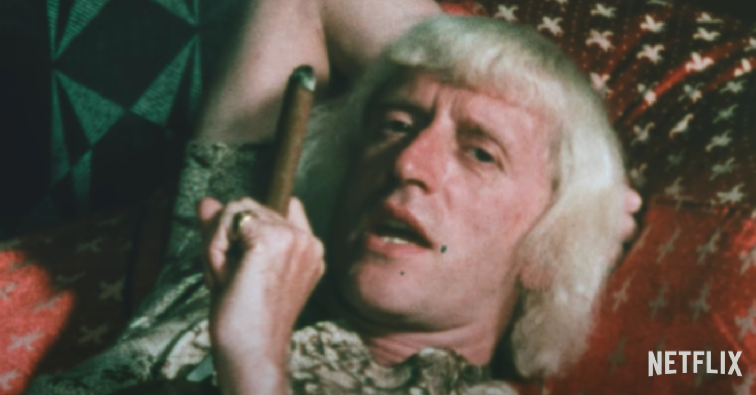Jimmy Savile, lying down, smoking a cigar in the trailer of the new Netflix documentary