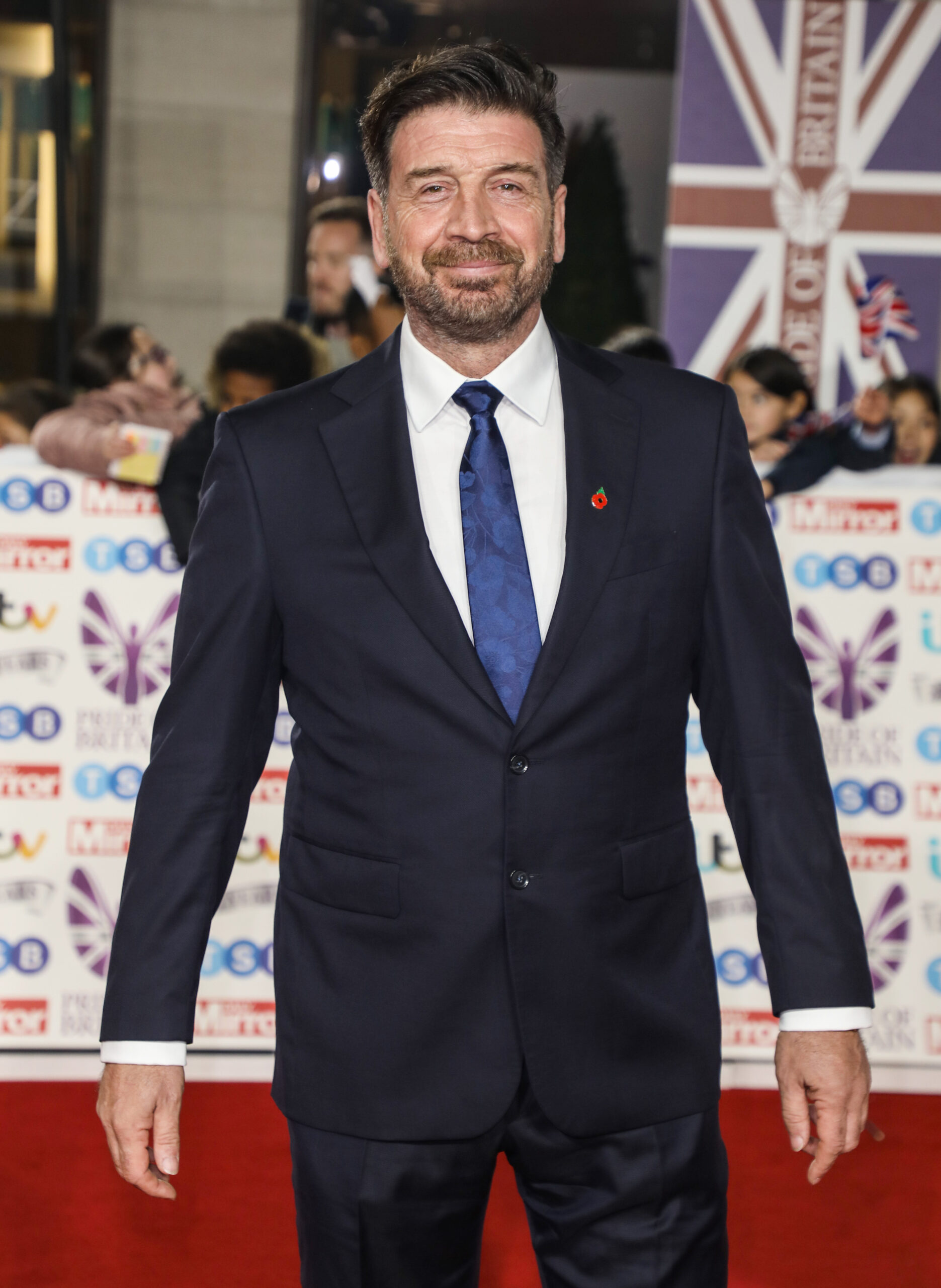 Nick Knowles smiling in a suit