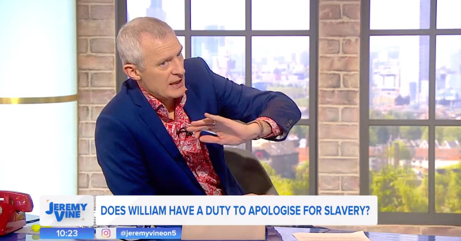 Jeremy Vine in a blue suit and red patterned shirt