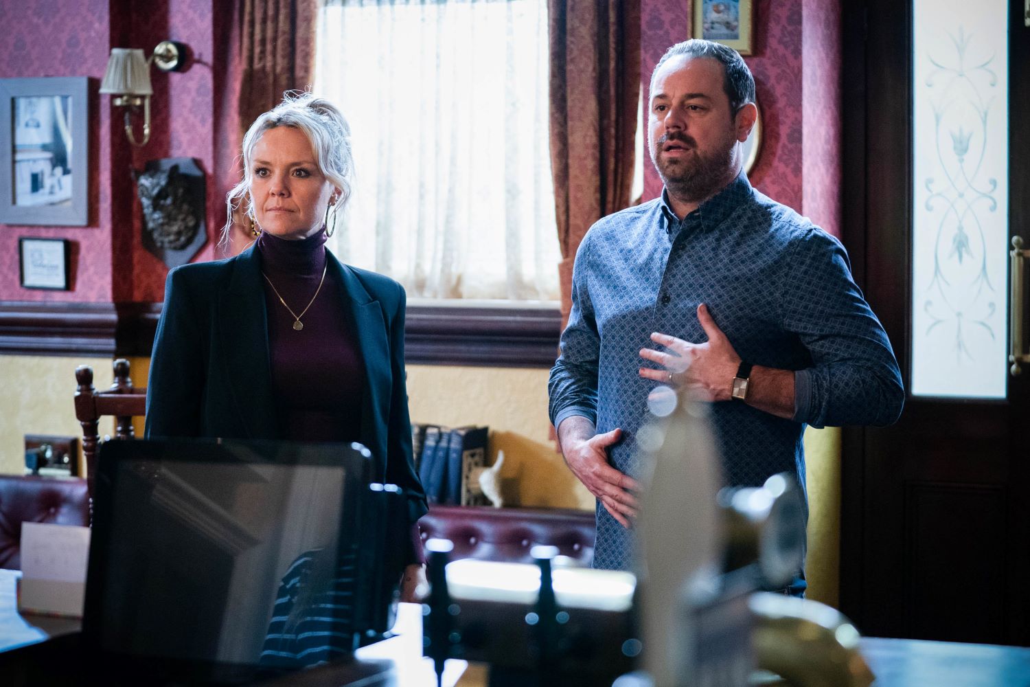 Janine and Mick look shocked in EastEnders