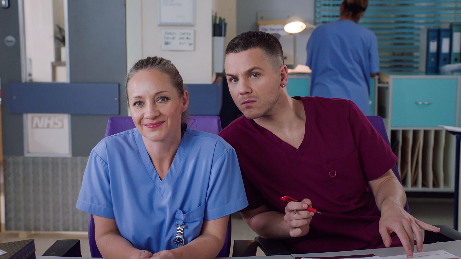 Two characters from holby city in scrubs