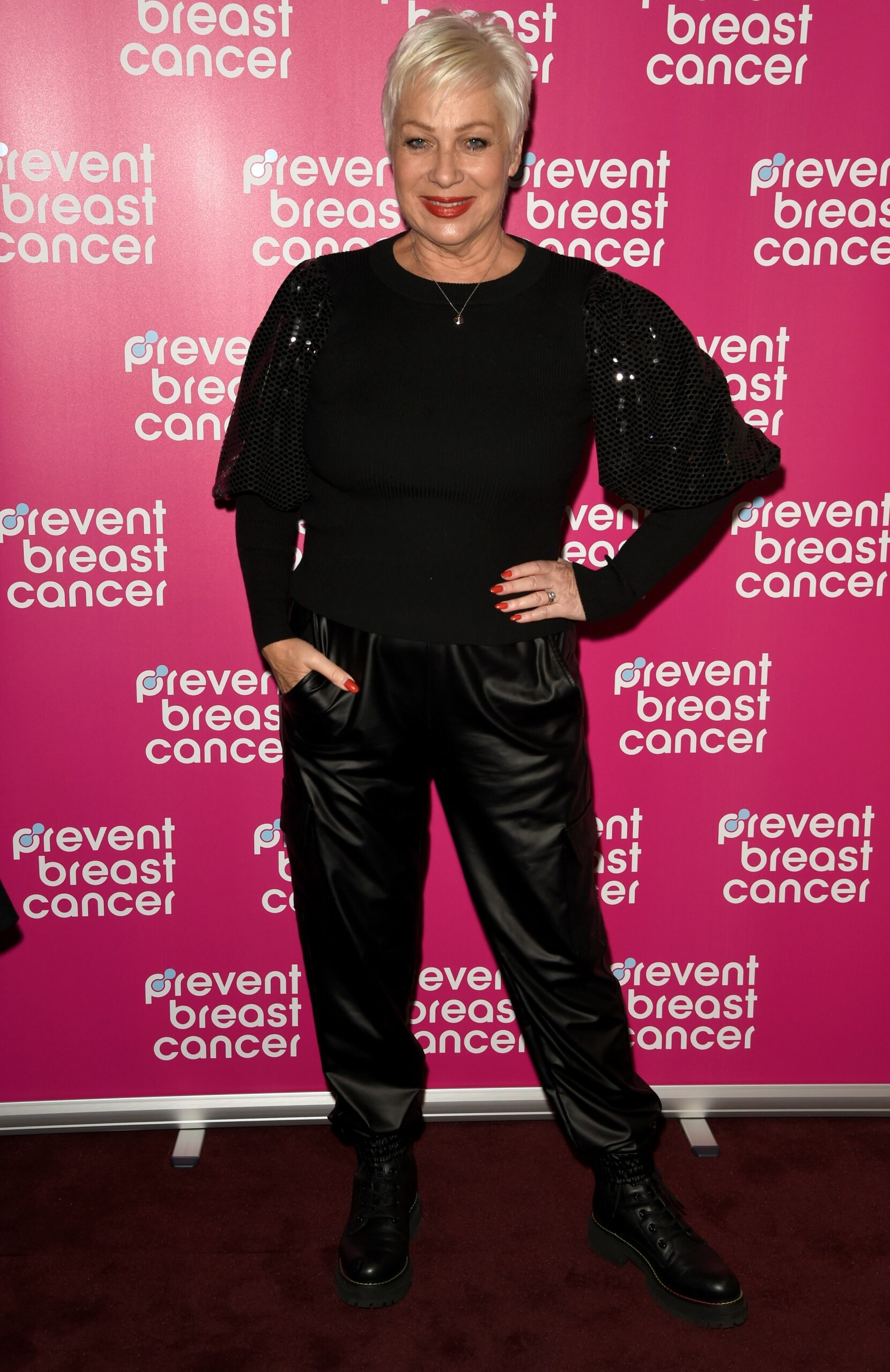 Denise Welch wears all black outfit as she poses at event
