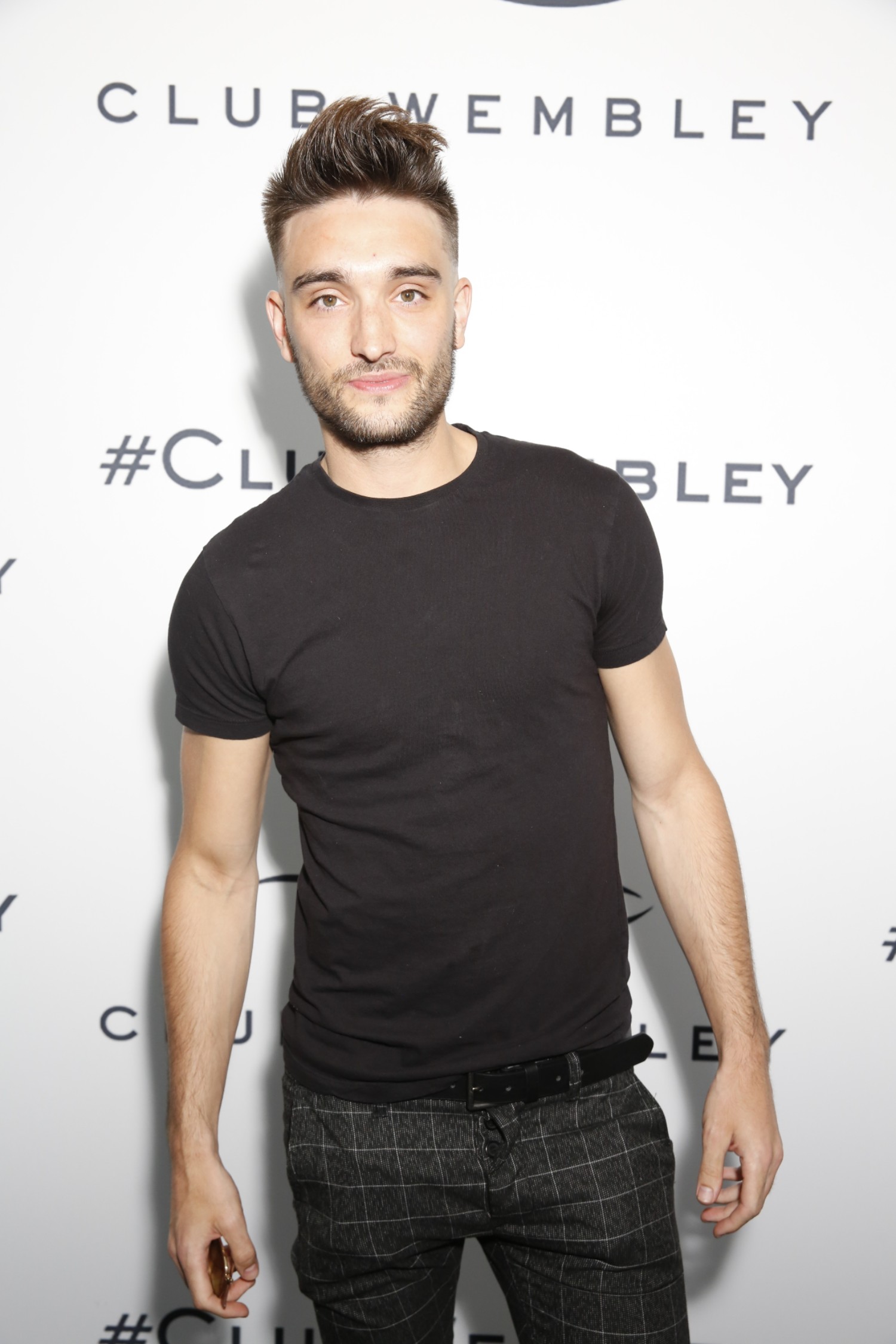 Tom Parker smiling wearing a black T-shirt